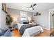 Cozy bedroom with hardwood floors, ceiling fan and natural light from the window at 3080 S Eudora St, Denver, CO 80222