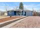 Cozy blue home with a charming exterior, complemented by a well-maintained driveway at 3080 S Eudora St, Denver, CO 80222