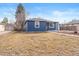 A beautiful blue home with an expansive front lawn and manicured landscape at 3080 S Eudora St, Denver, CO 80222