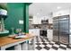 Modern kitchen featuring stainless appliances, checkerboard floors and crisp white cabinets at 3080 S Eudora St, Denver, CO 80222