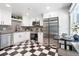 Modern kitchen with stainless steel appliances, checkerboard floors and crisp white cabinets at 3080 S Eudora St, Denver, CO 80222