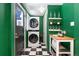 Laundry room with washer and dryer on a checkerboard floor, with shelves and wall decor at 3080 S Eudora St, Denver, CO 80222