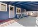 Charming blue-covered patio with seating, ideal for relaxing or entertaining outdoors at 3080 S Eudora St, Denver, CO 80222