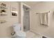 Bathroom with tiled floors, glass shower door, and decorative shelves with plant at 7291 E Bentley Cir, Centennial, CO 80122