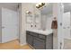 Neutral bathroom features a gray vanity with a single sink, and two light fixtures at 7291 E Bentley Cir, Centennial, CO 80122