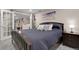 Inviting bedroom featuring a comfortable bed, bedside table, and ample lighting with view to the doorway and second room at 7291 E Bentley Cir, Centennial, CO 80122