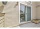 Outdoor deck features a sliding glass door and a small flower bed at 7291 E Bentley Cir, Centennial, CO 80122