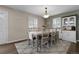 Well-lit dining room with hardwood floors and access to kitchen at 7291 E Bentley Cir, Centennial, CO 80122