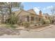 Charming brick home featuring a covered front porch and well-maintained landscaping at 7291 E Bentley Cir, Centennial, CO 80122