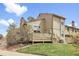 Back exterior view of a multi-story home featuring a deck, lawn and wood siding at 7291 E Bentley Cir, Centennial, CO 80122