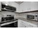 Updated kitchen features granite counters, stainless steel appliances and white cabinets at 7291 E Bentley Cir, Centennial, CO 80122