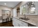 Open kitchen featuring stainless sink, and white cabinets; dining room visible in the background at 7291 E Bentley Cir, Centennial, CO 80122