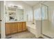 Bright bathroom featuring a double vanity, soaking tub, and glass-enclosed shower at 8510 Bluegrass Cir, Parker, CO 80134