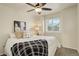 Comfortable bedroom featuring soft lighting, a ceiling fan, and a window view at 8510 Bluegrass Cir, Parker, CO 80134