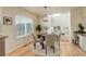 Bright dining area features wood floors, modern light fixture, and a large window at 8510 Bluegrass Cir, Parker, CO 80134