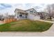 Charming two-story home featuring a well-manicured lawn, a covered porch, and an attached two-car garage at 8510 Bluegrass Cir, Parker, CO 80134