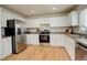 Well-lit kitchen with stainless steel appliances, white cabinetry, and light countertops at 8510 Bluegrass Cir, Parker, CO 80134
