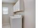 Practical laundry room with white cabinets and a large washing machine at 8510 Bluegrass Cir, Parker, CO 80134