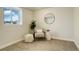 Relaxing room featuring a cozy chair, ottoman, and window with natural light at 8510 Bluegrass Cir, Parker, CO 80134