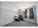 Grey-walled bedroom with carpet flooring, a window, and storage containers at 7345 S Eagles Nest Cir, Littleton, CO 80127