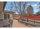 Relax in the backyard with a charming deck area, bench, and dining table at 3175 Zinnia Ct, Golden, CO 80401