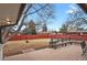 Enjoy the spacious backyard featuring a wood deck, bench, and mature trees at 3175 Zinnia Ct, Golden, CO 80401