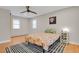 Cozy bedroom with hardwood floors, a ceiling fan, and ample natural light at 3175 Zinnia Ct, Golden, CO 80401