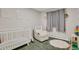 Cozy Bedroom with a crib, chair, and soft rug, creating a comfortable space at 3175 Zinnia Ct, Golden, CO 80401