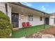 Close up of the welcoming porch with a secure screen door, house number and cozy red chairs at 3175 Zinnia Ct, Golden, CO 80401