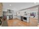 Modern kitchen featuring white cabinets, stainless steel appliances, and a seamless flow into the living areas at 3175 Zinnia Ct, Golden, CO 80401