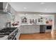 Modern kitchen features stainless steel appliances, hardwood floors, white cabinetry and large windows at 3175 Zinnia Ct, Golden, CO 80401