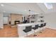 Open floor plan with a kitchen featuring a breakfast bar, modern lighting, and seamless flow into the living area at 3175 Zinnia Ct, Golden, CO 80401
