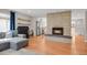 Open-concept living room with a cozy fireplace, hardwood floors, and a seamless flow into the kitchen at 3175 Zinnia Ct, Golden, CO 80401