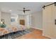 Spacious primary bedroom features hardwood floors, a ceiling fan, and a decorative sliding barn door at 3175 Zinnia Ct, Golden, CO 80401