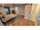 Bright main bedroom featuring hardwood floors, a ceiling fan, and a sliding barn door to the bathroom at 3175 Zinnia Ct, Golden, CO 80401