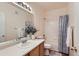 Bright bathroom featuring a shower and tub combination with a large mirror and single sink at 14700 E 104Th Ave # 2802, Commerce City, CO 80022
