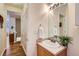Bathroom with a single sink, large mirror and neutral paint at 14700 E 104Th Ave # 2802, Commerce City, CO 80022