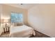 Bedroom featuring a comfortable bed, soft lighting, and a large window at 14700 E 104Th Ave # 2802, Commerce City, CO 80022