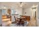Dining area features a wooden table and chairs and adjacent kitchen at 14700 E 104Th Ave # 2802, Commerce City, CO 80022