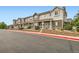 A row of townhouses featuring pleasant exteriors, landscaping, and convenient street access at 14700 E 104Th Ave # 2802, Commerce City, CO 80022