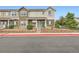 Inviting townhouse featuring a charming front porch and manicured landscaping for great curb appeal at 14700 E 104Th Ave # 2802, Commerce City, CO 80022