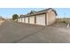 Exterior view of multiple garages with individual doors and parking spaces at 14700 E 104Th Ave # 2802, Commerce City, CO 80022