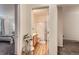 Hallway view leading to bathroom with wood floors and neutral paint at 14700 E 104Th Ave # 2802, Commerce City, CO 80022