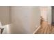 Hallway featuring a bathroom with wooden floors and neutral paint at 14700 E 104Th Ave # 2802, Commerce City, CO 80022