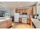 Bright kitchen features stainless steel appliances, wood cabinets, hardwood floor and recessed lighting at 14700 E 104Th Ave # 2802, Commerce City, CO 80022