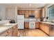 Bright kitchen features stainless steel appliances, wood cabinets, hardwood floor and a window at 14700 E 104Th Ave # 2802, Commerce City, CO 80022