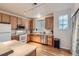 Kitchen with wooden cabinets, a refrigerator, and a view from the window at 14700 E 104Th Ave # 2802, Commerce City, CO 80022
