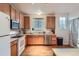 Bright kitchen features stainless steel appliances, wood cabinets, hardwood floor and a view of the window at 14700 E 104Th Ave # 2802, Commerce City, CO 80022