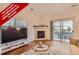 Bright living room with a fireplace and access to an outdoor patio, blending indoor and outdoor living at 14700 E 104Th Ave # 2802, Commerce City, CO 80022