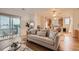 Open-concept living room flows into the kitchen with hardwood floors and a modern sofa at 14700 E 104Th Ave # 2802, Commerce City, CO 80022